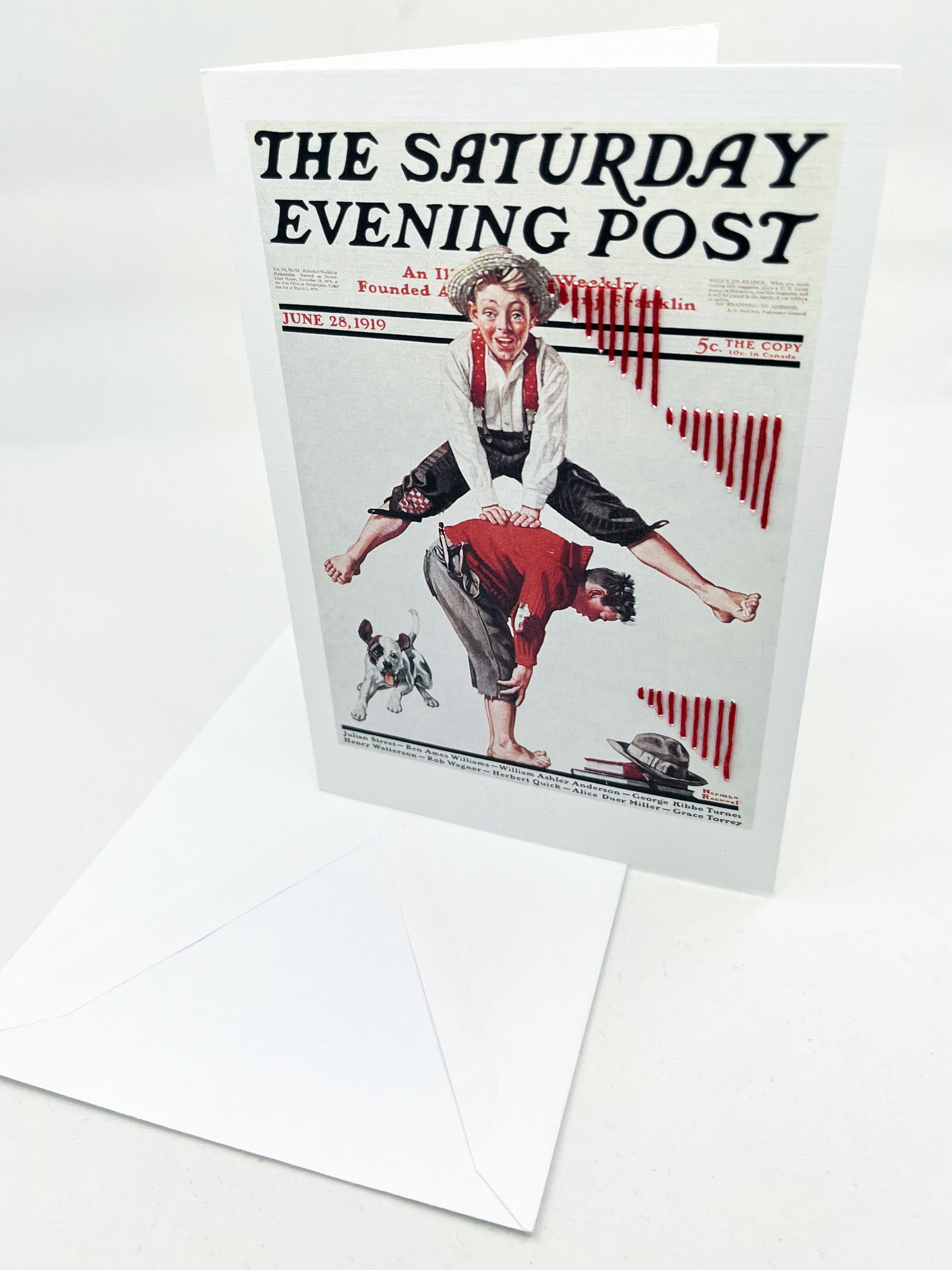 greeting card with a print of an issue of The Saturday Evening Post, a picture of a boy jumping over another boy, a with triangles made of red stripes hand embroidered around them