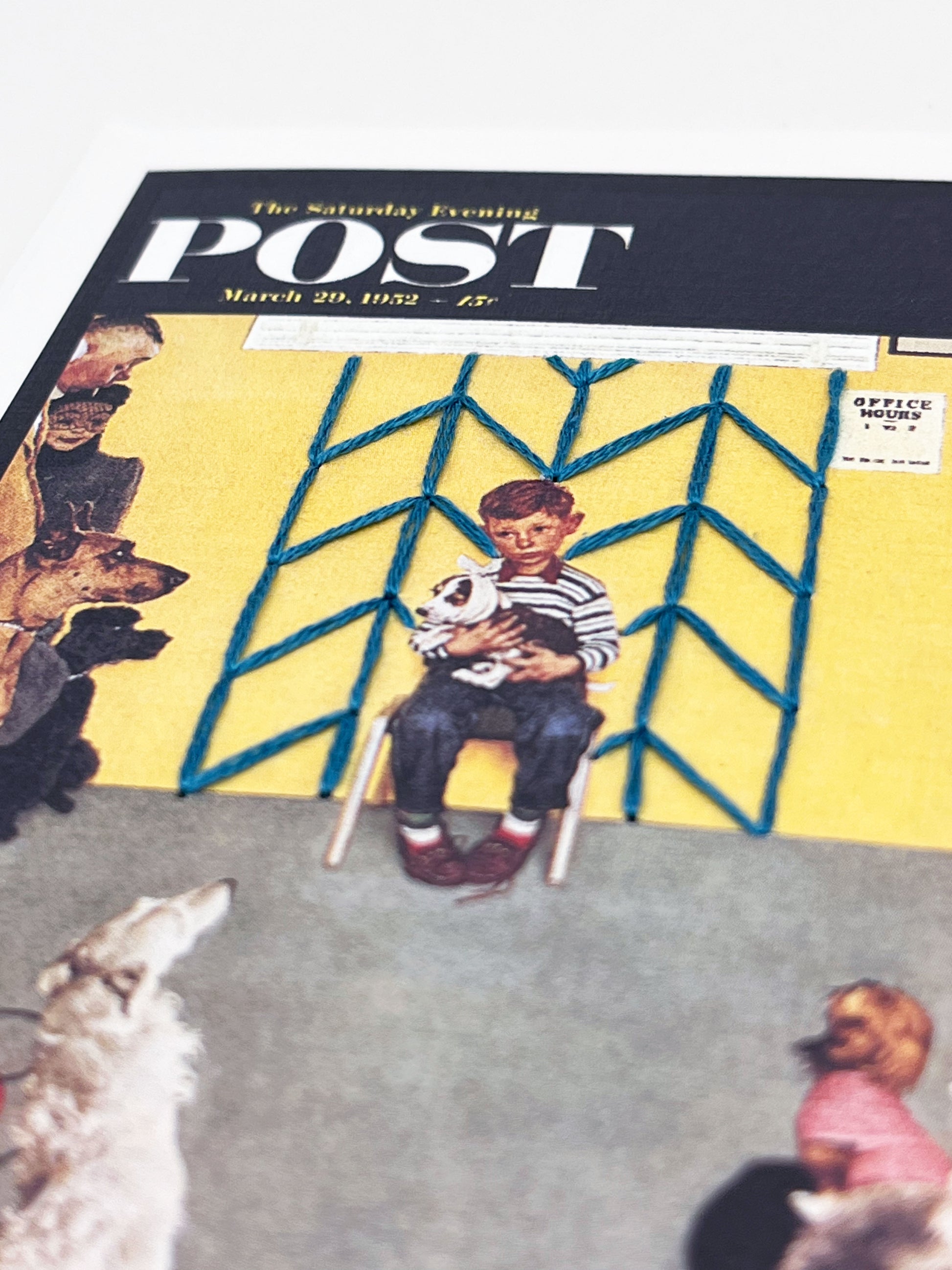 greeting card with a print of an issue of The Saturday Evening Post, a picture of a a boy holding his dog at the vet looking worried, with hand embroidered chevron pattern  on the wall behind him